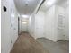 Bright hallway with carpet, neutral walls, and doors to other rooms at 102 Lake Tracy Ct, Haines City, FL 33844