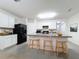 Modern kitchen with white cabinets, island, and stainless steel appliances at 102 Lake Tracy Ct, Haines City, FL 33844