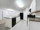 Modern kitchen with white cabinets, island, and stainless steel appliances at 102 Lake Tracy Ct, Haines City, FL 33844