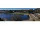 Serene pond with walking path and surrounding trees at 102 Lake Tracy Ct, Haines City, FL 33844