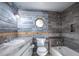 Modern bathroom with wood-look tile and a bathtub at 1109 Lakeshore Blvd, St Cloud, FL 34769
