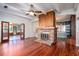 Living room with hardwood floors, a brick fireplace, and high ceilings at 1109 Lakeshore Blvd, St Cloud, FL 34769