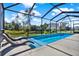 Relaxing screened pool with plenty of lounge chairs at 1235 Amazon Ln, Poinciana, FL 34759