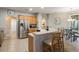Stainless steel refrigerator and light wood cabinets in open kitchen at 144 Costa Loop, Auburndale, FL 33823
