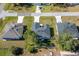 Aerial view of three houses with gray roofs and small yards at 1603 Tench Ct, Kissimmee, FL 34759