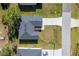 Aerial view of a house and driveway, surrounded by grass at 1603 Tench Ct, Kissimmee, FL 34759
