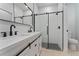Modern bathroom with white vanity, black fixtures, and a large walk-in shower at 1603 Tench Ct, Kissimmee, FL 34759