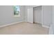 Well-lit bedroom featuring tile floors and a double-door closet at 1603 Tench Ct, Kissimmee, FL 34759