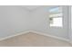 Simple bedroom with neutral walls, tile floors, and a window at 1603 Tench Ct, Kissimmee, FL 34759