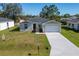 Newly constructed home with a two-car garage and landscaped yard at 1603 Tench Ct, Kissimmee, FL 34759