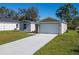 New construction home with a two-car garage and neat landscaping at 1603 Tench Ct, Kissimmee, FL 34759