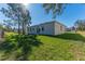 Tan house exterior with sliding glass doors leading to the backyard at 1603 Tench Ct, Kissimmee, FL 34759