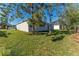 House exterior showcasing a side view and backyard landscape at 1603 Tench Ct, Kissimmee, FL 34759