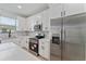 Modern kitchen with white cabinets, stainless steel appliances and quartz countertops at 1603 Tench Ct, Kissimmee, FL 34759