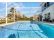 Screened pool with lake view and lounge chairs at 254 Hills Bay Dr, Davenport, FL 33896