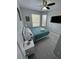 Bedroom with a queen-size bed, teal bedding, and grey wood-look flooring at 2778 Almaton Loop # 303, Kissimmee, FL 34747