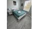 Bedroom with a queen-size bed, teal bedding, and grey wood-look flooring at 2778 Almaton Loop # 303, Kissimmee, FL 34747