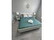 Main bedroom with king-size bed, teal bedding and grey wood-look flooring at 2778 Almaton Loop # 303, Kissimmee, FL 34747