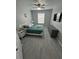 Main bedroom with king-size bed, teal bedding, and grey wood-look flooring at 2778 Almaton Loop # 303, Kissimmee, FL 34747