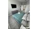 Main bedroom with a king-size bed, teal bedding and grey wood-look flooring at 2778 Almaton Loop # 303, Kissimmee, FL 34747
