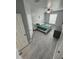 Main bedroom with a king-size bed, teal bedding and grey wood-look flooring at 2778 Almaton Loop # 303, Kissimmee, FL 34747