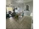 Open concept dining room with a light wood table and seating for six at 2778 Almaton Loop # 303, Kissimmee, FL 34747