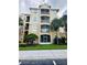 Three-story condo building with palm trees and ample parking at 2778 Almaton Loop # 303, Kissimmee, FL 34747