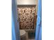 Small bathroom with a toilet, shower and patterned shower curtain at 453 Hunter Circle, Kissimmee, FL 34758