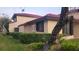Side view of the condo, showcasing the building's architectural details and landscaping at 453 Hunter Circle, Kissimmee, FL 34758