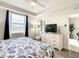 Comfortable bedroom with a dresser, TV, and a view from the window at 4741 Clock Tower Dr # 205, Kissimmee, FL 34746