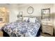 Bright bedroom with a floral comforter and en-suite bathroom at 4741 Clock Tower Dr # 205, Kissimmee, FL 34746