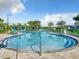 Resort-style pool with lounge chairs and shaded areas at 4741 Clock Tower Dr # 205, Kissimmee, FL 34746