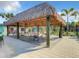 Relaxing shaded seating area with tables under a tiki hut at 4741 Clock Tower Dr # 205, Kissimmee, FL 34746