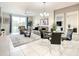 Open concept dining area with glass table and seating for four at 4741 Clock Tower Dr # 205, Kissimmee, FL 34746