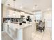 Open concept kitchen with white cabinets and a breakfast bar at 4741 Clock Tower Dr # 205, Kissimmee, FL 34746