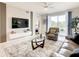 Spacious living room with large TV and comfy seating at 4741 Clock Tower Dr # 205, Kissimmee, FL 34746
