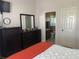 Bedroom with ensuite bathroom access and dresser at 5062 El Destino Dr, Leesburg, FL 34748