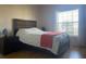 Comfortable bedroom with a double bed, nightstand, and large window at 5062 El Destino Dr, Leesburg, FL 34748