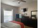 Bright bedroom with a queen bed, dresser, and large window at 5062 El Destino Dr, Leesburg, FL 34748