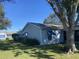 Side view of the house showing landscaping and yard at 5062 El Destino Dr, Leesburg, FL 34748