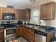 Well-equipped kitchen featuring stainless steel appliances and wood cabinets at 5062 El Destino Dr, Leesburg, FL 34748