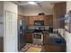 Modern kitchen with stainless steel appliances and wood cabinets at 5062 El Destino Dr, Leesburg, FL 34748