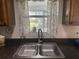 Clean kitchen sink with a double basin and a window overlooking the backyard at 5062 El Destino Dr, Leesburg, FL 34748