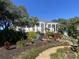 Landscaped grounds with waterfall and tropical plants at 5062 El Destino Dr, Leesburg, FL 34748