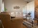 Living room with beige sofas, a coffee table, and hardwood floors at 5062 El Destino Dr, Leesburg, FL 34748