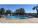 Inviting community pool with lounge chairs and lake view at 5062 El Destino Dr, Leesburg, FL 34748