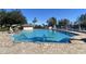 Refreshing community pool with lake view and lounge chairs at 5062 El Destino Dr, Leesburg, FL 34748