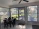 Screened porch with table, chairs, and backyard view at 5062 El Destino Dr, Leesburg, FL 34748