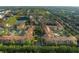 Aerial view showing apartment buildings, landscaping, and a pond at 902 Charo Pkwy # 636, Davenport, FL 33897