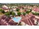 Aerial view of community with multiple buildings and pools at 902 Charo Pkwy # 636, Davenport, FL 33897